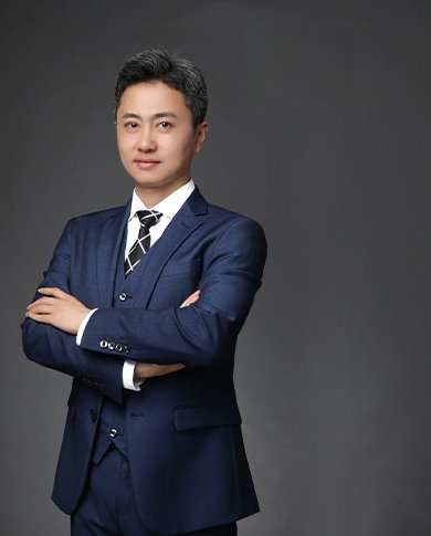 Professional staff of magnet factory, dressed in blue suit, standing with arms crossed