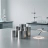 Laboratory setup with metallic cylindrical samples and testing tools to verify if galvanised steel is magnetic